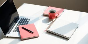 Bright workspace with laptop and planner for productivity.